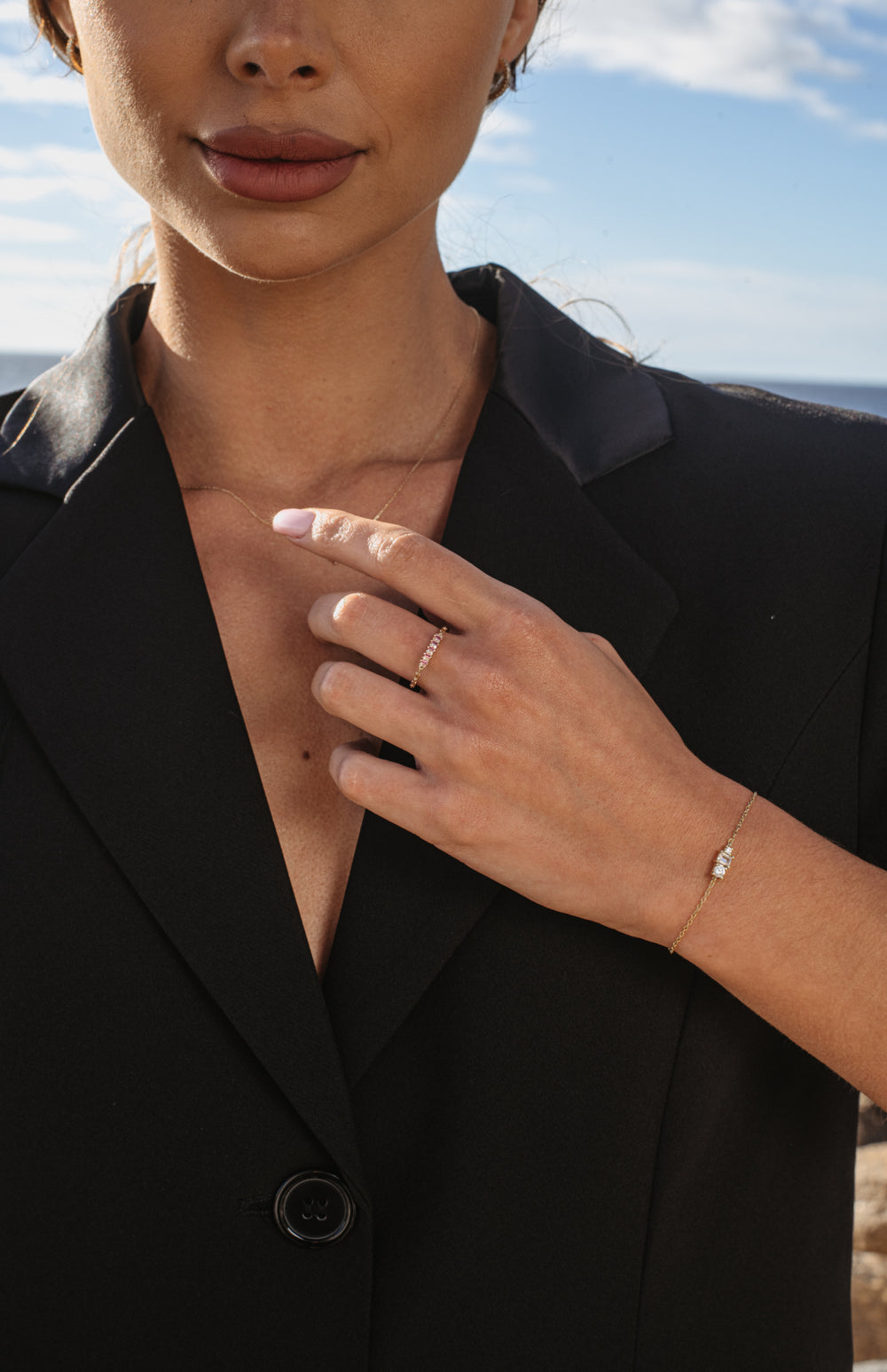 Model with gold ring on beach