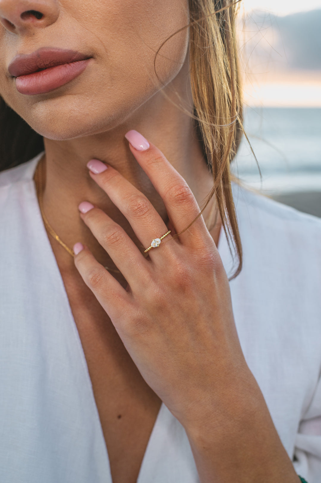 gold plated ring on model at beach