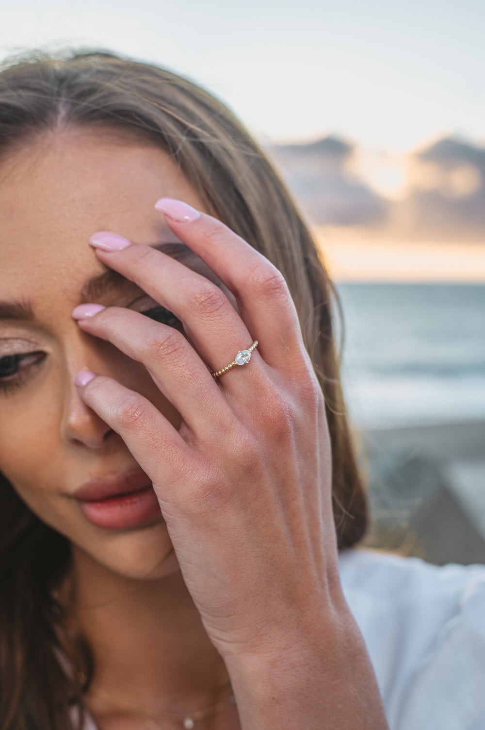 gold plated ring on model at beach